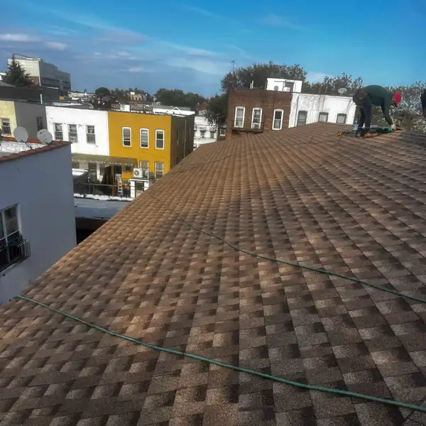 Close-up of a finished brown architectural shingle roof